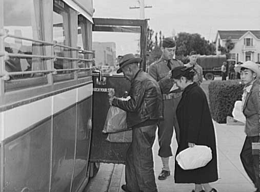 Salinas, California. Japanese-Americans boarding bus for transportation to reception center. Russell Lee,photographer, 1942 May. Library of Congress.