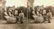 Adults Seated, Facing Camera, Child Playing in Barrel in Foreground, Plantation Setting