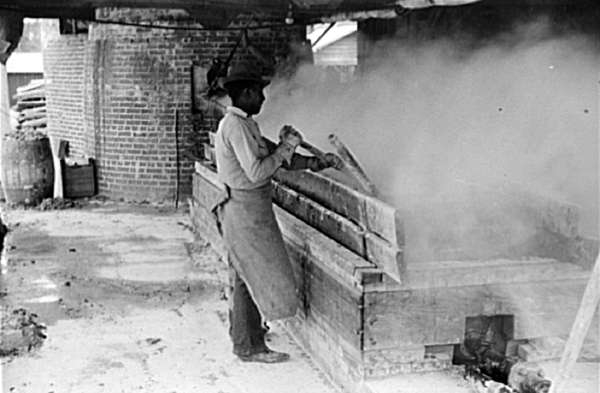 Filtering Hot Rosin through Sieves at a Turpentine Works in Statesboro, Georgia