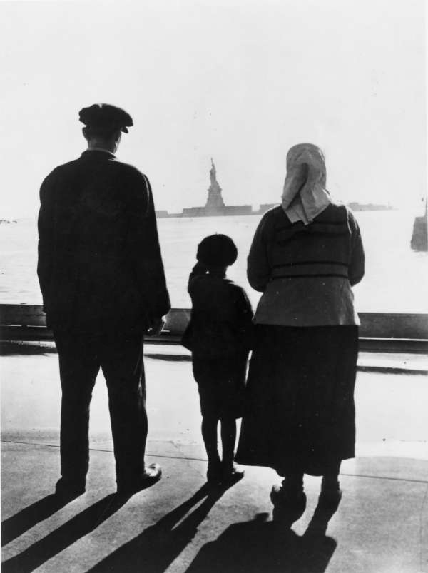 Immigrant Family Looking at The Statue of Liberty