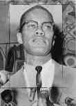 Malcolm X, Head-and-Shoulders Portrait, Facing Slightly Right at Microphones