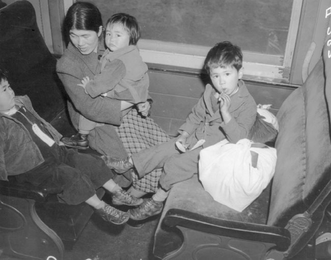 Mother and three children on train from Los Angeles to Manzanar