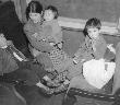 Mother and three children on train from Los Angeles to Manzanar